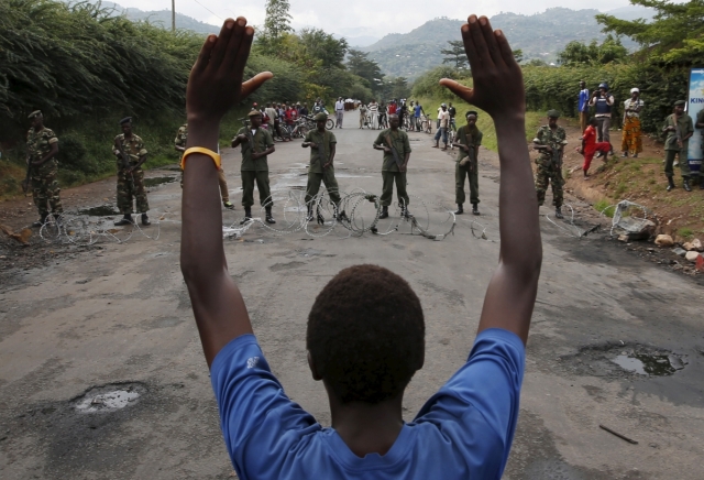 A protester holds his hands up in front of soldiers during a protest against Burundi President Pierre Nkurunziza and his bid for a third term in Bujumbura, May 19. Goran Tomasevic/Reuters 